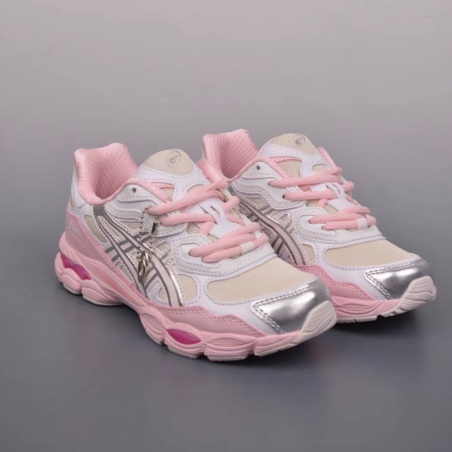 White and pink sneakers with metallic silver accents and pink laces on a gray background.