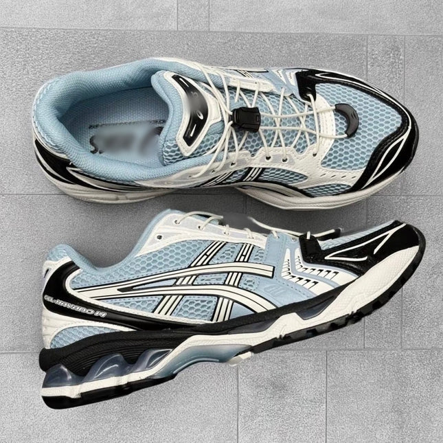 Light blue and black sneakers with white accents on a gray tiled background.