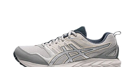 Gray running shoe with mesh fabric, textured sole, and dark accents on a white background.