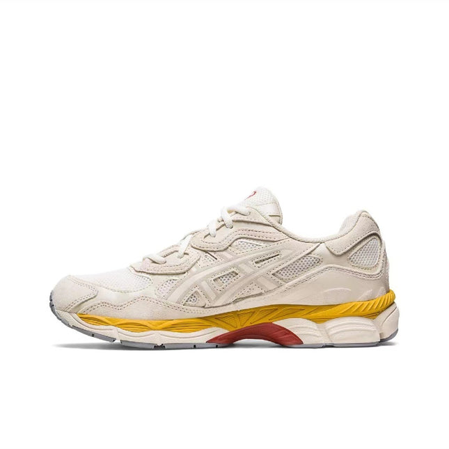 Beige sneaker with mesh panels, yellow and red accents on the sole, and a textured design.