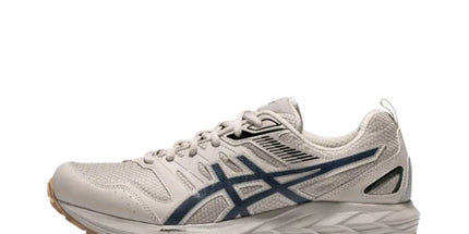 Beige sneaker with dark blue logo, textured mesh upper, and tan sole on a white background.
