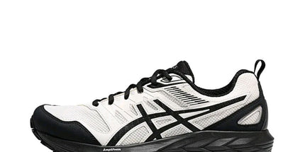 White and black athletic shoe with mesh upper, black sole, and logo stripe on the side.