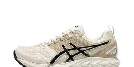 Beige and white athletic shoe with black logo, textured sole, and lace-up design.