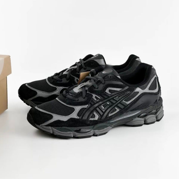 Black and gray athletic shoes with mesh texture and intricate sole, next to a cardboard box.