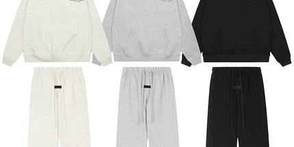 Set of three hoodies and three pairs of pants in white, gray, and black on a white background.
