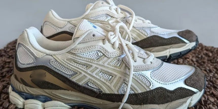 White mesh sneakers with beige and brown accents on a bed of coffee beans.