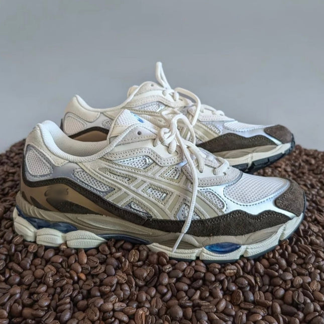 White mesh sneakers with beige and brown accents on a bed of coffee beans.