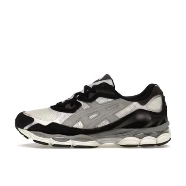 Black and white sneaker with mesh panels, gray accents, and a chunky white and gray sole.