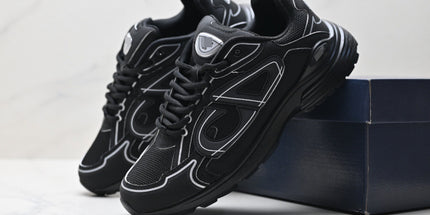 Black sneakers with white accents on a light gray background