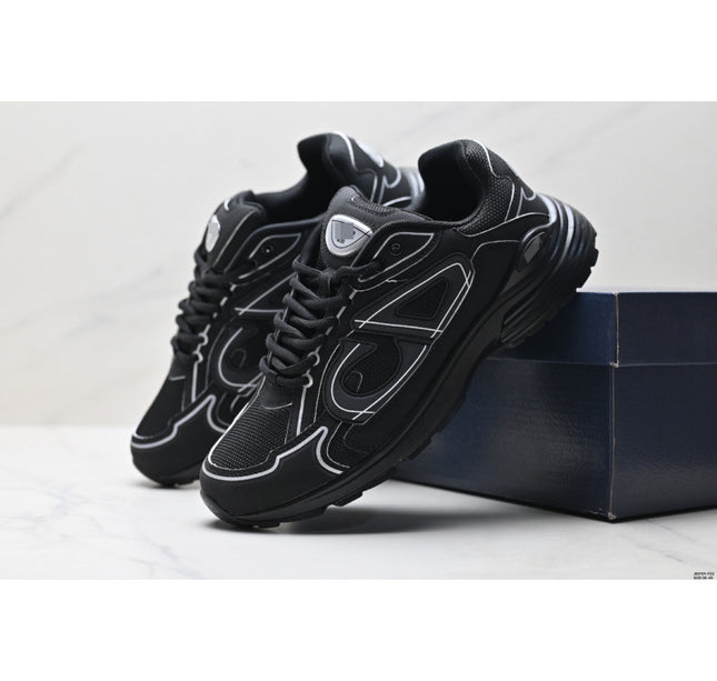 Black sneakers with white accents on a light gray background