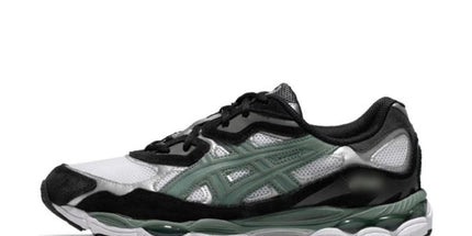 Black, white, and green sneaker with mesh texture, black laces, and a thick sole.