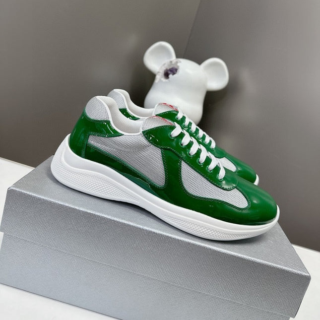 Green and white sneakers on a gray box with a blurred white object in the background