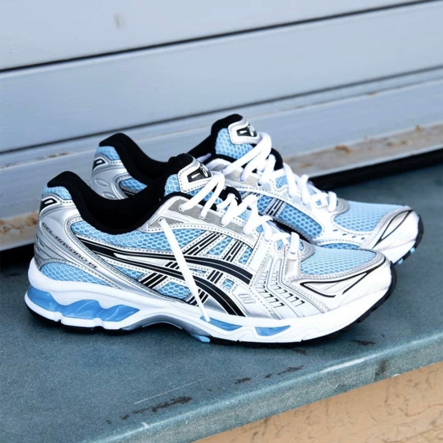White and blue running shoes with black accents and white laces on a blue surface.