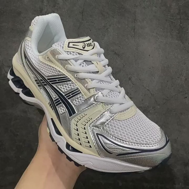 White sneaker with silver accents, black logo, and textured mesh pattern on a gray background.
