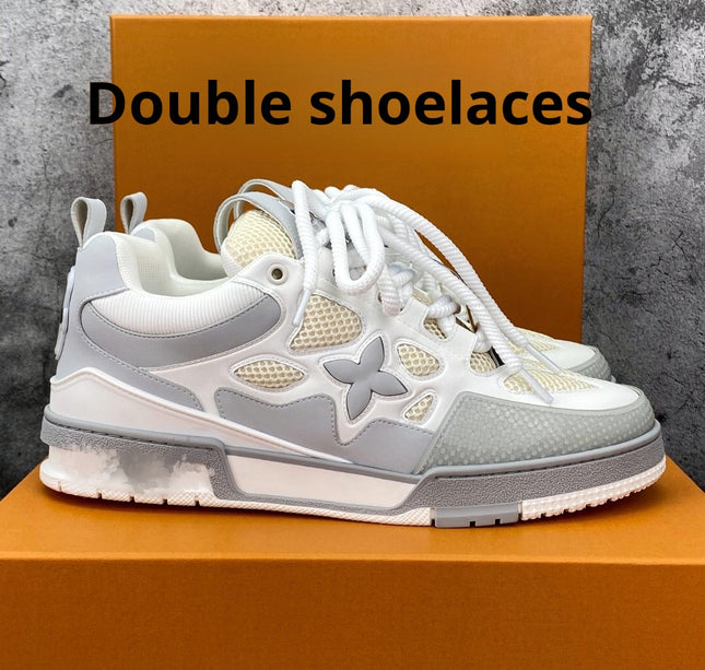 Gray and white sneaker with double shoelaces on an orange box against a gray background.